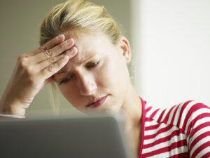 woman having headache with hands on temple. Copy space